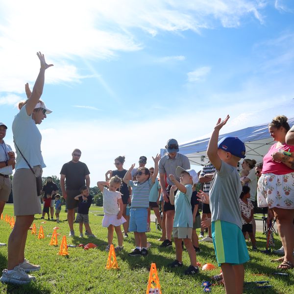Kids and parents celebrate with arms in the air